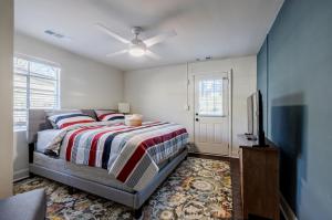a bedroom with a bed and a flat screen tv at 5 min Grant park with Fenced Yard Parking Pet Friendly in Atlanta