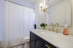 a bathroom with a sink and a toilet at 5 min Grant park with Fenced Yard Parking Pet Friendly in Atlanta +3 photos
