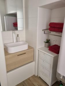 a bathroom with a sink and a mirror at U STUDIU 7 rue Notre Dame in Bastia