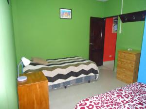 a bedroom with two beds and a dresser and a bed sidx sidx at Apartamento Top House in Puerto Baquerizo Moreno
