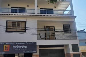 een gebouw met een balkon en een bord erop bij Casa no Centro de São Lourenço in São Lourenço