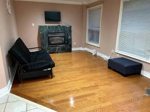 a living room with a couch and a fireplace at Room for Rent Room 1 in Brampton