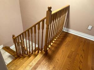 a wooden staircase with a wooden floor in a room at Room for Rent Room 1 in Brampton
