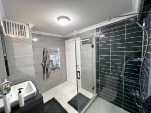 a bathroom with a glass shower and a sink at NEW Citrus Garden Home Duplex in Mudanya