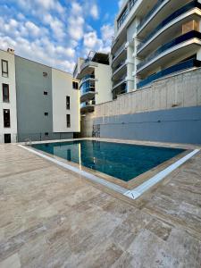 a swimming pool in front of a building at NEW Citrus Garden Home Duplex in Mudanya