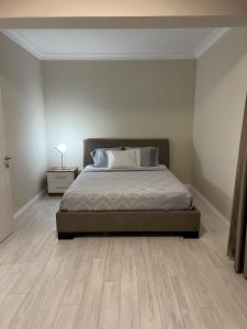 a bedroom with a bed and a wooden floor at NEW Citrus Garden Home Duplex in Mudanya