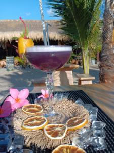 a drink in a wine glass sitting on a table at Hakuna Matata Resort Gili Air in Gili Air