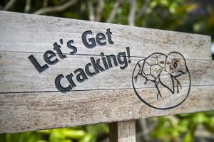 a wooden sign that says lets get cracking at Six Senses Con Dao - Turtle Island Paradise in Con Dao