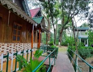 a building with a bunch of chairs in front of it at Jaldapara Jungle Camp I Family Resort by StayApart in Mādāri Hāt