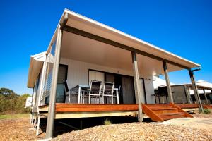 a house with a porch with chairs on it at BIG4 Saltwater @ Yamba Holiday Park in Yamba