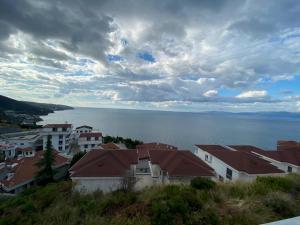 a group of houses on a hill next to the water at NEW Seaview Bachelor Apartment Privacy + Closets in Mudanya