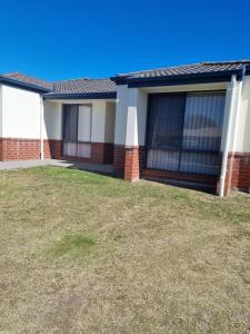 a house with a lawn in front of it at BLK Stays Guest House Deluxe Units Bellmere 