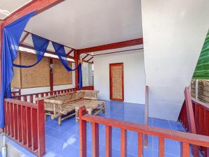 a room with a balcony with a bench and a table at BLACK SWEET BUNGALOW in Gili Air