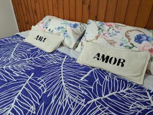 a bed with two pillows on top of it at Hostel Belgrano Home in Monte Grande