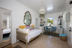 a bedroom with a bed with a large mirror at Watercolor home in Harbour Island