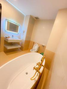 ein Badezimmer mit einer Badewanne, einem Waschbecken und einem WC in der Unterkunft Huong Mai Hotel in Da Lat