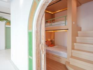 a bedroom with a bunk bed and a staircase at Puri Rinjani Bungalows & Hostel in Kuta Lombok