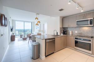 a kitchen with a sink and a counter top at Stunning Apartment in Downtown Doral in Miami