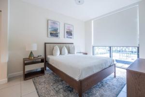 a bedroom with a large bed and a large window at Stunning Apartment in Downtown Doral in Miami +22 photos