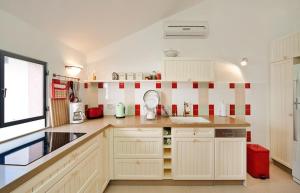 a kitchen with white cabinets and red and white tiles at Lovely 2BR Apt w Balcony in Neve Tzedek Area Sea N' Rent in Tel Aviv