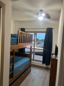 a small room with a bunk bed and a window at Lagoon Village, Playa Escondida in Colón