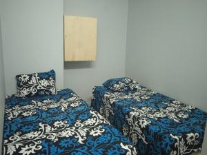 two beds sitting next to each other in a room at Elephantina sobek guest house in Aswan +34 photos