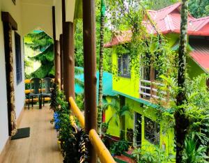 a balcony of a house with green plants at Jaldapara Wild Huts by StayApart in Mādāri Hāt