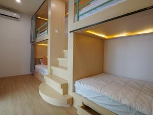 a bedroom with a bed and stairs in a room at Puri Rinjani Bungalows & Hostel in Kuta Lombok