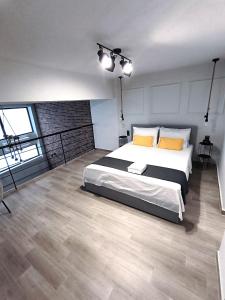 a bedroom with a large bed with yellow pillows at ZOE LOFT in Kavála
