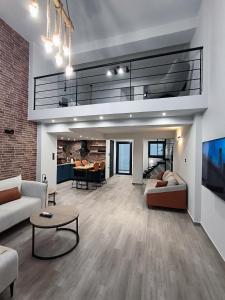 a large living room with a couch and a table at ZOE LOFT in Kavála