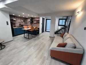 a living room with a couch and a table at ZOE LOFT in Kavála