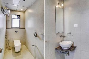 a bathroom with a toilet and a sink and a mirror at FabHotel Ansh in Aurangabad