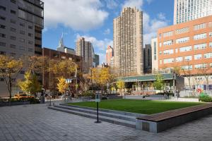 a park in the middle of a city with tall buildings at Murray Hill 2br w gym lounge nr East River NYC-944 in New York