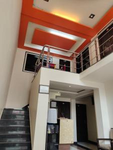 a staircase in a house with orange ceilings at Avadh vihara Beds & Breakfast in Varanasi