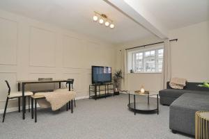 a living room with a couch and a tv at Stylish apartment, Barbican in Plymouth