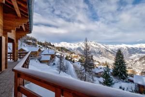 a balcony with a view of a snow covered mountain at Chalet Alaska in La Tzoumaz