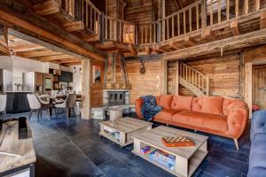 a living room with a couch and a table at Chalet Alaska in La Tzoumaz +48 photos