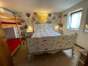 a bedroom with a bed and a stone wall at Casa Samuela 