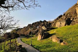 a stone path on a hill with a house on it at Dimoski Apartment in Prilep