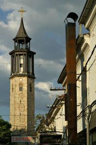 a tall clock tower with a cross on top of it at Dimoski Apartment in Prilep