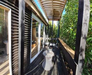 a porch with a toilet on a house at Lodge in the Woods in Puerto Montt