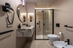 a bathroom with a shower and a toilet and a sink at Duomo Collection in Milan