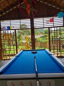 a pool table in a room with a playground at Little Bee in Luong Son