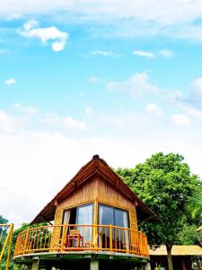 a house with a balcony on top of it at Little Bee in Luong Son