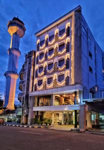 a building with a mosque in front of it at Hotel 88 Alun Alun Bandung By WH in Bandung