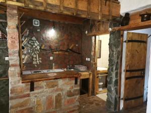 a kitchen with a stone wall and a stove at Apartmani Pinkum in Veliko Gradište