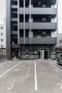 an empty parking lot in front of a building at Essence in Sapporo