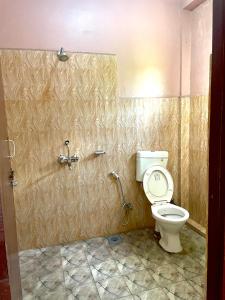 a bathroom with a toilet and a shower at Hotel Tree Tops- A Serene Friendly Hotel in Sauraha in Chitwan