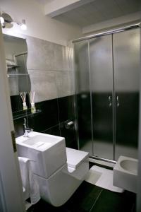 a bathroom with a shower and a toilet and a sink at San Giorgio by PizzoApartments in Pizzo +37 photos