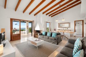 a living room with a couch and a table at Villa Michaela in Sant Lluis